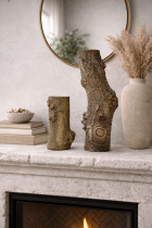 Rustic mantel decor with sculptures and vase