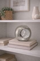 Decorative orb on a serene bookshelf