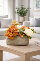 Floral arrangement on light wood table
