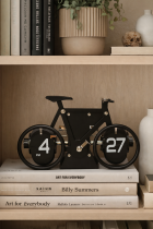 Bicycle clock on a wooden bookshelf