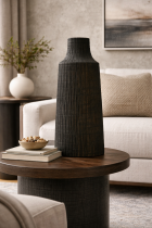 Textured black vase on wooden table