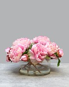 Round glass vase with Pink Peonies in faux water