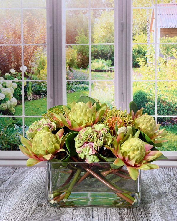 Square glass vase with Protea in faux water