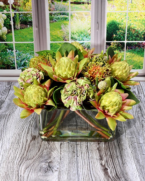 Square glass vase with Protea in faux water