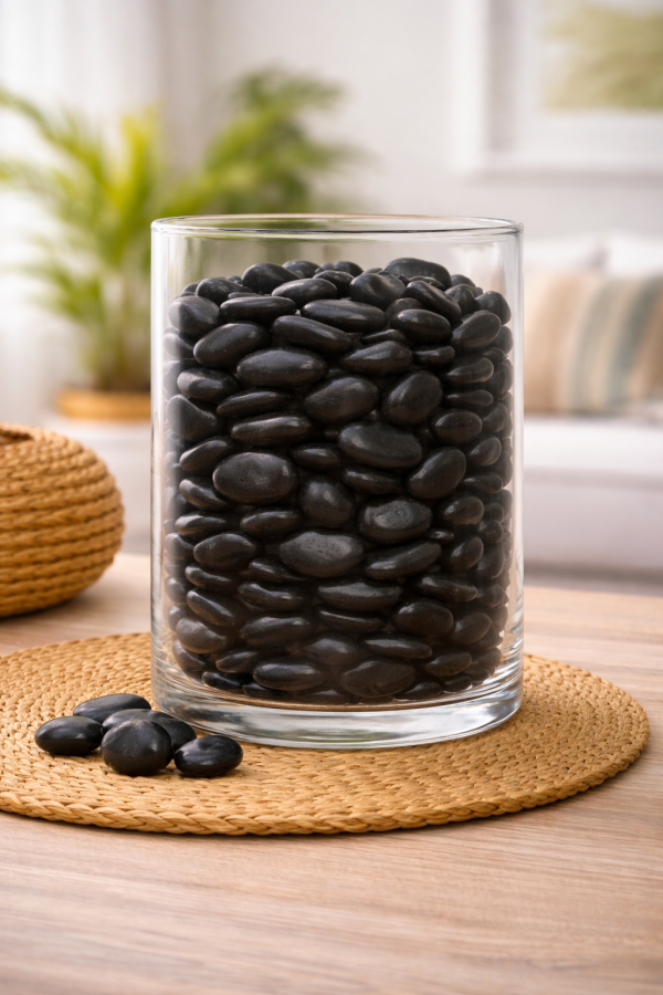 Vase filled with polished black stones